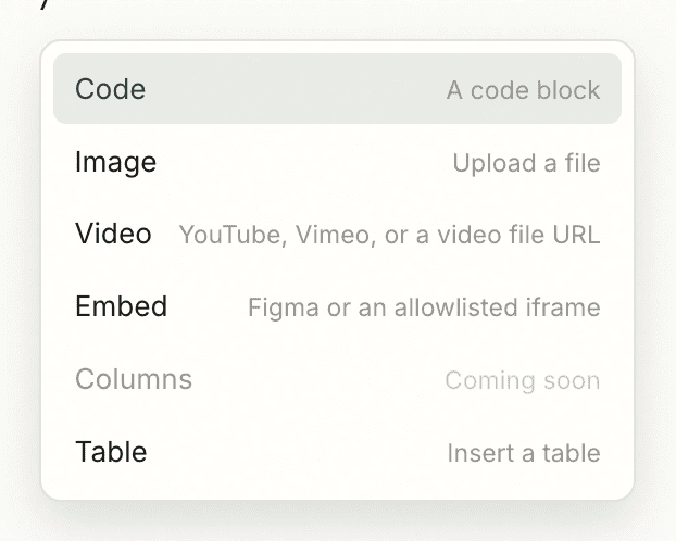The slash menu open in the editor, offering Code, Image, Video, Embed, and Table